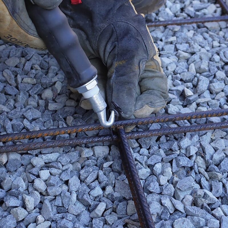 Black rod tying tool with a long handle, perfect for tying garden stakes and reinforcing structures.